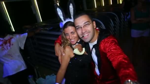 2 in 1 young and old Hugh Hefner with Playboy bunnys, Happy Halloween.People in costumes dance at Halloween party in club October 31, 2016, New York, USA