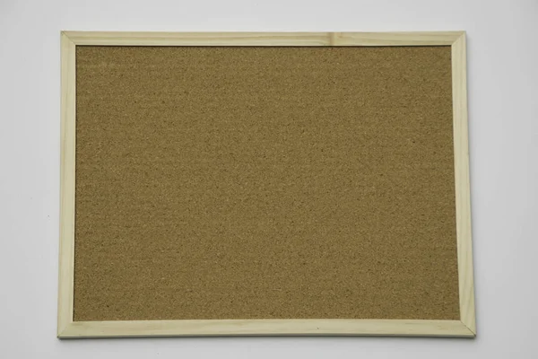 Blank cork board mock up with cork-board texture background with wooden frame hanging on white wood wall (isolated with clipping path) for bulletin pin-up mock-up, memo or noticeboard announcement