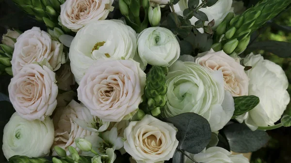 A bouquet of light rose roses and white peony with green decoration - Close up
