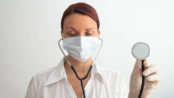 Tired Female Doctor Medical Mask Her Face Holding Stethoscope Her — Stock Photo, Image