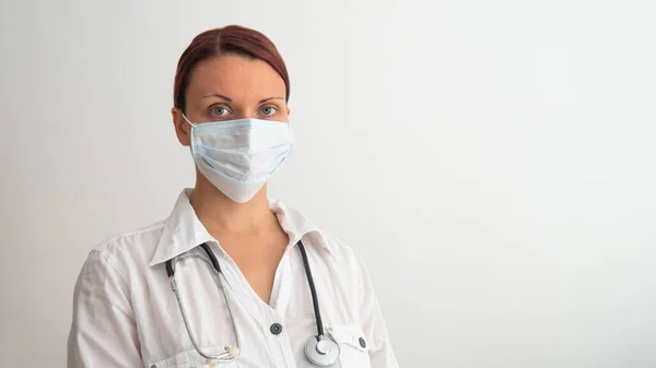Young Female Doctor Medical Mask Her Face Stethoscope White Background — Stock Photo, Image