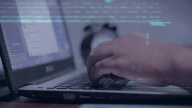 Ekranda veri kodu olan bir bilgisayar korsanı kullanıyor.