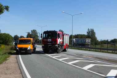 23 Ağustos'ta A8 yolda, Letonya, iki kamyon çarpışması oluştu, Iveco insanlar üzerinde yaya geçidi gördüm ve keskin, Scania sürüş sürücü frenlenir 2018.The kamyon şoförü mesafe değil gözlemlemek ve Ive koştu
