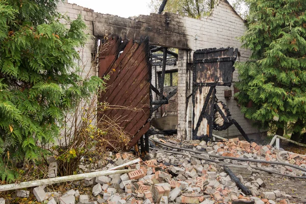 the ruins of a fully burned farm, disaster scene