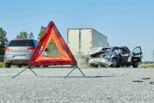 Sinal de emergência na estrada no local de um acidente de carro — Fotografia de Stock