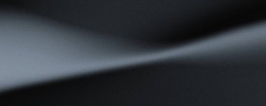 Kara kumlu yüzey dramatik ışık ve gölge oyunuyla. Güçlü çapraz ışık kaynağı tarafından aydınlatılan karanlık ve dokulu bir yüzeye yakın çekim görüntüsü derin gölgeler ve gölgeler yaratır..