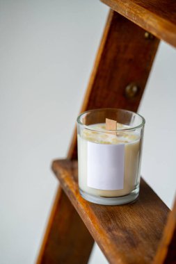 Ahşap fitili olan şık bir ev dekorasyonu. Etiketli soya mumundan yanan mum.