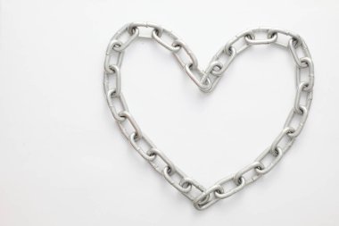 A metallic chain with a shiny, industrial finish, coiled and displayed against a clean white background. Heart Shape.