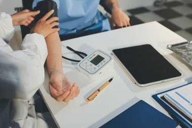 Hastanedeki hastanın kan basıncını ölçen doktor. Sağlık Hizmetleri Konsepti