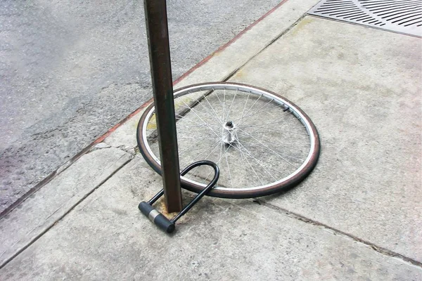 Bike wheel with padlock. Theft of a bicycle. Bicycle stolen and left only wheel