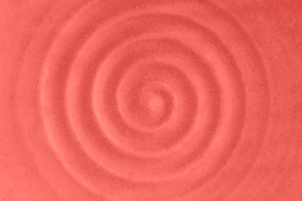 Coral color background. Ceramic dish. Circular vibrations. Ceramic pattern