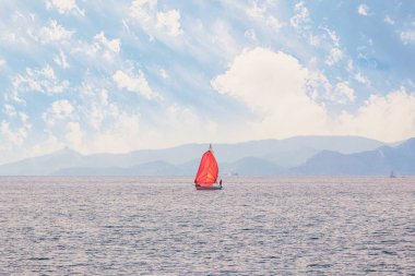 Sakin Denizi üzerinde kırmızı bir yelken yelkenli tekne. Atina, Yunanistan