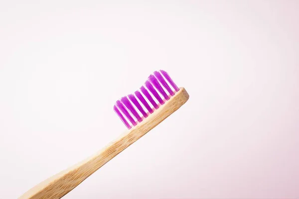 Pink bamboo toothbrush on a light background. Eco friendly concept. Copy space — Stock Photo, Image