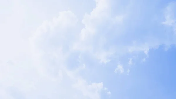 Scenic soft light sky. Beautiful white soft fluffy clouds on a blue sky background. 16:9 panoramic format