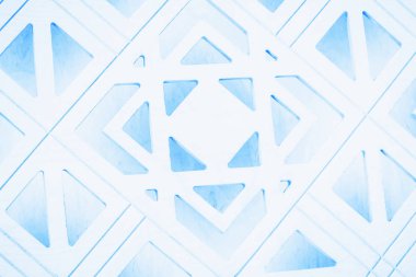 Beyaz ve açık mavi geometrik arkaplan. Elle oyulmuş ahşap kapı. Parça, detaylar