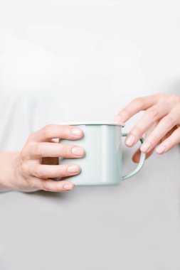 Mine bardağı tutan güzel kadın elleri. Çıplak oje ile Manikür. Kopyalama alanı