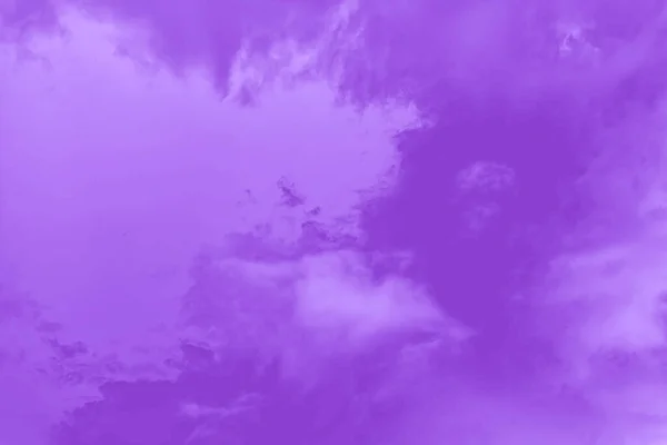 Purple fluffy clouds in the sky, violet sky background