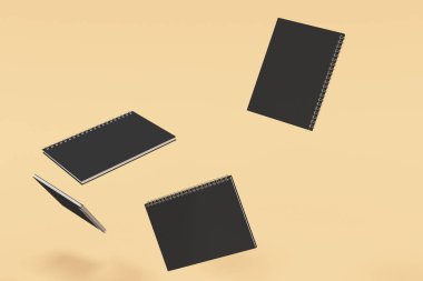 Siyah kapakları ve metal spiral ile dört boş dizüstü bilgisayar üzerinde turuncu arka plana bağlı. İş veya eğitim mockup. 3D render illüstrasyon