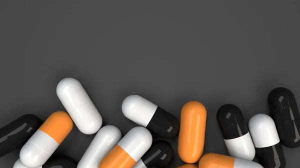 Pile de capsules de médecine noire, blanche et orange — Photo