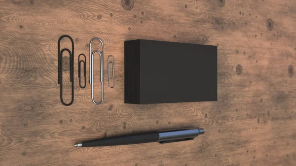 Black business cards, paper clips and automatic ballpoint pen on wooden table. Blank paper mockup. 3D rendering illustration.