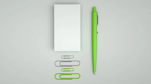 White business cards, paper clips and green automatic ballpoint pen isolated on white background. Blank paper mockup. 3D rendering illustration.