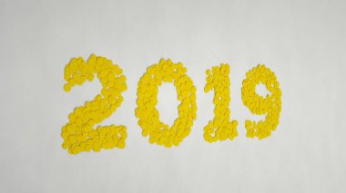 2019 number made from yellow confetti on white background. 2019 new year sign. 3D rendering illustration