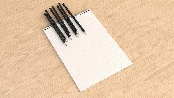 Notebook met zwarte potloden — Stockfoto