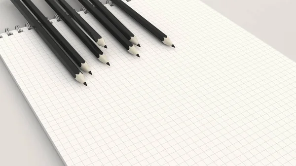 Notebook with black pencils