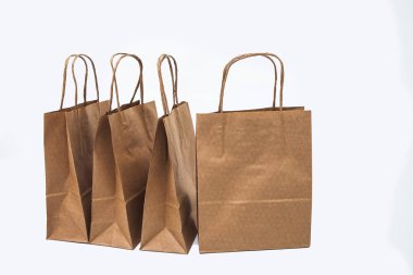 Kraft torba üst üste - beyaz bir arka plan üzerinde Satılık, alışveriş ve hediyeler