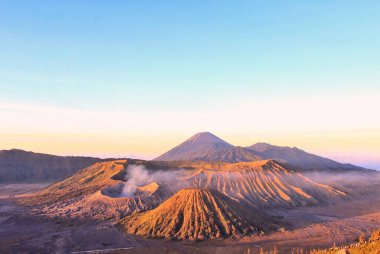 Mount Bromo volcano at sunrise. Golden light at Mount Bromo. Beautiful view of Mount Bromo in the morning with a clear blue sky