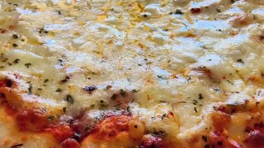 A closeup of a delicious cheese pizza with fresh herbs and spices, perfect for food lovers everywhere