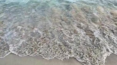 Enjoy beautiful ocean views with waves caressing the sandy shore, perfect for tranquil and calming reflections