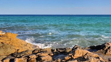 A tranquil scene of stunning blue waters crashing against rugged coastlines, perfect for nature enthusiasts