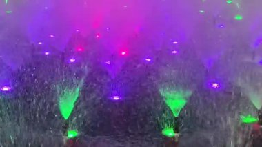 A vibrant fountain show featuring colorful lights and water jets, creating a mesmerizing visual experience.