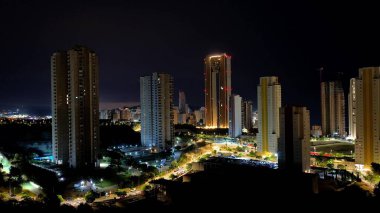 A breathtaking view of a city at night showcasing its bright skyscrapers and bustling, lively streets