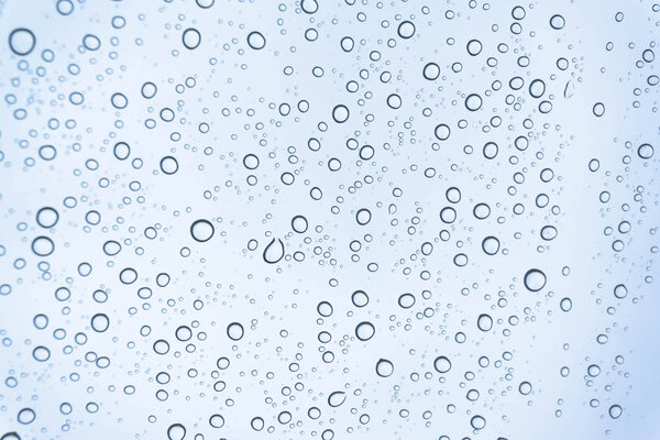 Rain on the window, natural skin of the rain The natural form of rainwater on a sky background.