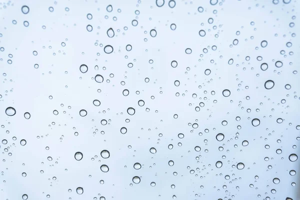 Rain on the window, natural skin of the rain The natural form of rainwater on a sky background.