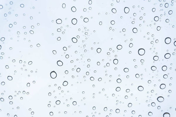 Rain on the window, natural skin of the rain The natural form of rainwater on a sky background.