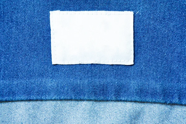 White clothes label on clothes background, clothes with label tag, white blank label on background,can used for display or montage your products, and your good for background.