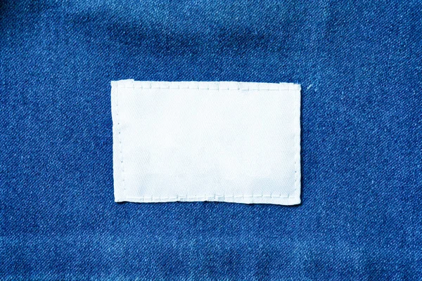 White clothes label on clothes background, clothes with label tag, white blank label on background,can used for display or montage your products, and your good for background.