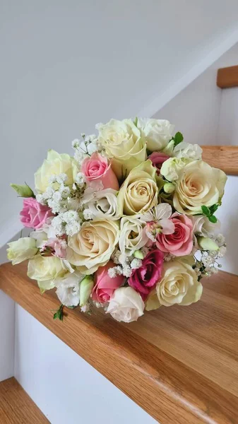 Bir buket gül ve alyans. İç kısımda bir düğün buketi. Gül buketi, mutluluk, çingene ve yeşillik..