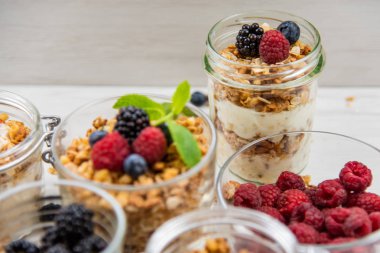 Kavanoz granola, yoğurt ve taze çilek, yakın çekim, seçici odak ile tam