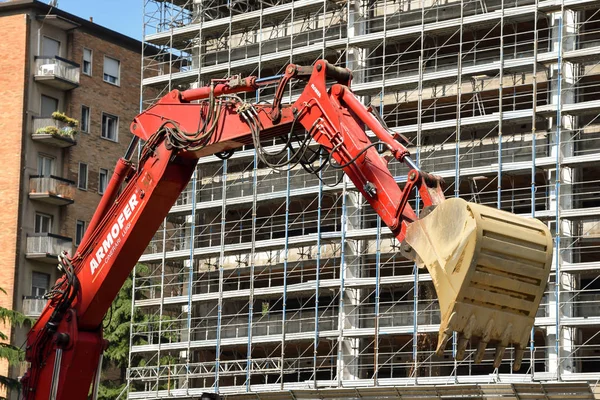 Milan, İtalya - 24 Mayıs 2018: Modern ekskavatör Kazı çalışmaları ve daha aptal kamyon, site bina sanayî Makinaları gerçekleştirir.