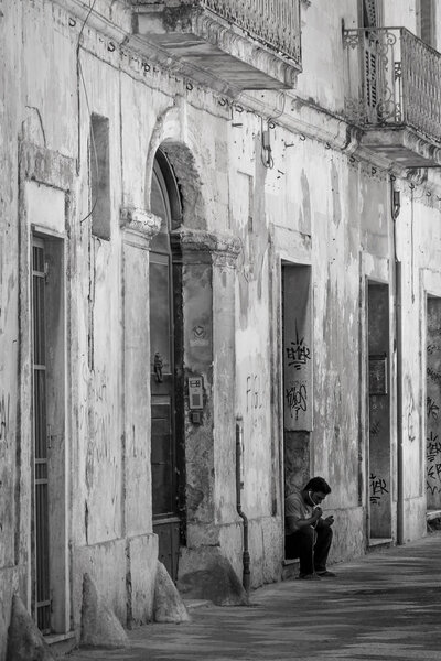 Lecce, Italy - July 21 2016: Charming street in old historic town of Lecce, Puglia, Italy, photo in black and white.