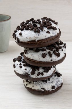 Beyaz ahşap arka planda çörek ve kahve fincanı, yakın plan.