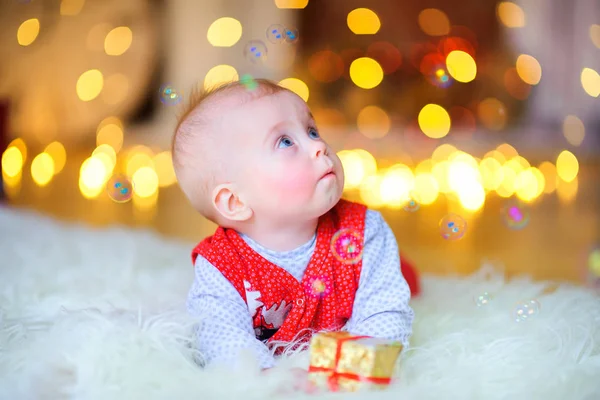 Funny Baby Lying Floor Gift Bright Lights Background — Stock Photo, Image