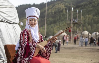 KYRCHYN, KYRGYZSTAN - SEPTEMBER 6TH, 2018: Kyrgyz woman singing during World Nomad Games 2018 clipart
