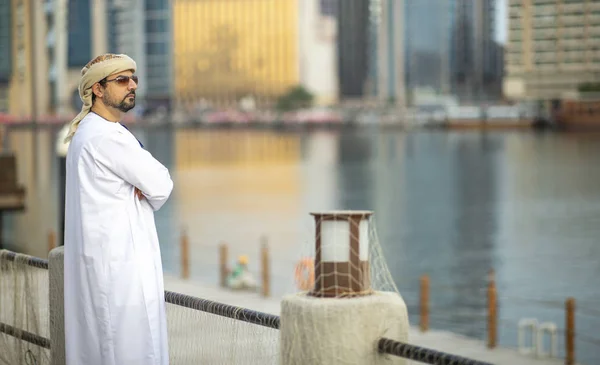 arab man standing on river bank in old Al Seef part of Dubai, United Arab Emirates