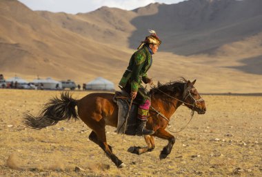 Bayan Ulgii, Mongolia - 3rd October 2015: kazakh man on horse in landscape of western mongolia clipart