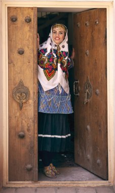 young beautiful Iranian lady in traditional clothing in village of Abyaneh